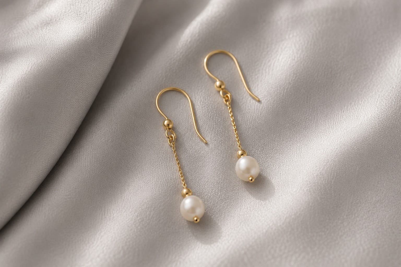 Delicate drop earrings with a small pearl detail